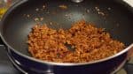 Distribute it evenly and stir-fry until the liquid is reduced almost completely. Place the meat mixture into a bowl.