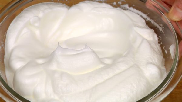 Beat until the meringue reaches a stiff peak stage. Lift the beaters to check if the stiff peaks form.