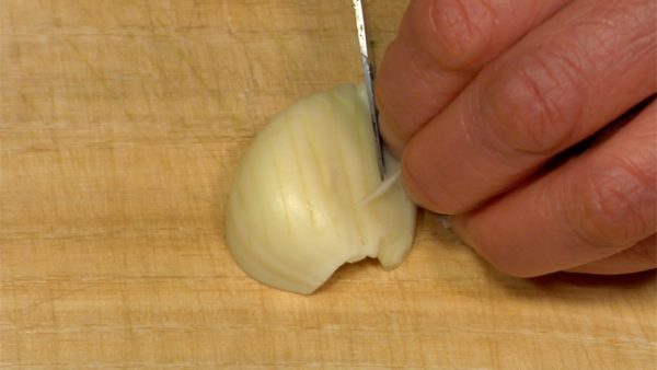 Remove the garlic sprout. Slice the garlic with the root end attached. Make cuts across the garlic parallel to the cutting surface. Chop across the other two cuts and mince well.