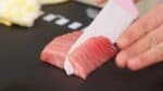 This is fresh tuna belly also known as chutoro. Slice it across the grain to give it a better texture. Chutoro has a moderate amount of fat and will deliciously melt in your mouth.