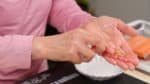 Wet your hands again and loosely shape about 20g (0.7 oz) of sushi rice into a ball. Hold the tuna slice with another hand and add the wasabi to it.