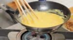 Heat the pan on low heat. Stir the mixture continuously while cooking. Lift the pan to adjust the heat.