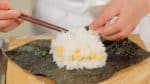 Taking a small portion of the rice at a time, cover the fillings evenly. Lightly sprinkle on salt.