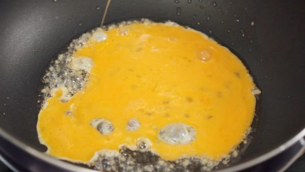 When the oil has heated, add the beaten egg.