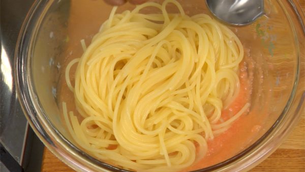 Place the pasta into the bowl of the mentaiko sauce. Add a spoonful of the remaining cooking water to moisten.
