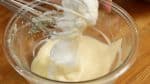 Add half of the meringue to the cheese mixture. Lift the mixture with a balloon whisk and gently drop it into the bowl. This will help to avoid breaking the foam and also combine the mixture quickly.