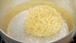 Drop the instant ramen into a large amount of boiling water.