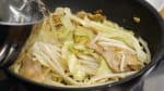 Continue sauteing the moyashi bean sprouts. When the vegetables are seasoned evenly, add 400ml (1.7 cups) of hot water.