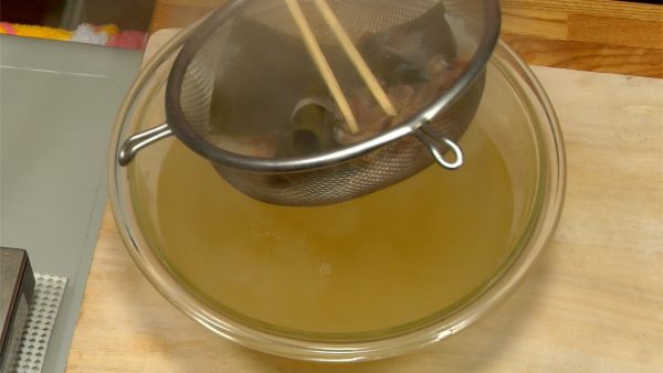 Squeeze out remaining water from the bonito flakes in order to get a delicious, rich dashi stock. You may substitute packaged dashi if kombu kelp and bonito flakes are not available.
