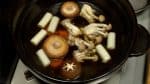 Add carrots, long green onions, shiitake and shimeji mushrooms.