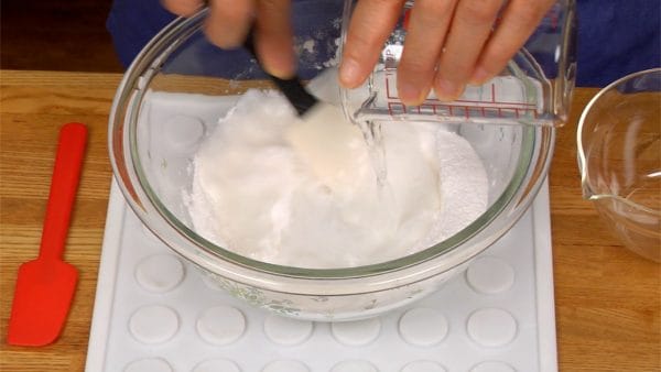 Add a little water at a time and mix just enough to get rid of the pockets of flour.