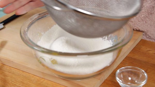 Next, combine the baking powder and cake flour or all purpose flour and lightly stir. With a fine mesh strainer, sieve the power 2 to 3 times to help the muffins to have a fluffy texture.