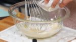 Let’s make the batter. Allow the butter, egg and milk to reach room temperature before using. This will keep the batter from separating. Using a balloon whisk, whip the butter in a bowl until it becomes creamy. Then, add a pinch of salt and half of the sugar and combine.