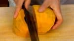 Cut the pumpkin vertically in half. Divide each of the halves into 2 slices.