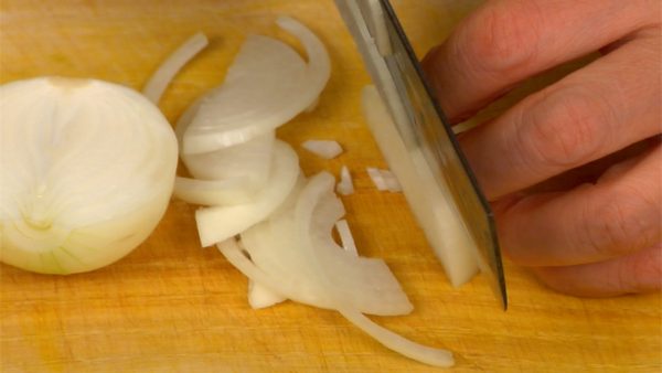 Next cut the onion in half. Remove the basal plate part of the root. Slice the onion across the grain into thin slices.