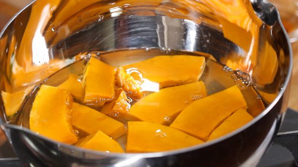 Place them into a pot. Pour the water over the kabocha until it is almost covered.