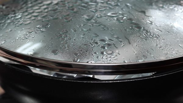 Place a lid on but leave it slightly off to help avoid overheating. Then, turn on the burner. When it begins to boil again, reduce the heat to low and simmer for 20 to 25 minutes. If it reaches a rolling boil, remove the lid to adjust the temperature.