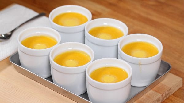 Remove the cups. The light-colored marks on the pudding are leftover foam that hardened on the surface. Let the pudding sit to cool and then make sure to chill it in the fridge.