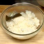 The fresh steamed rice is cooked with the kombu seaweed. Remove the kombu seaweed.