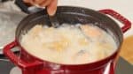 Le mélange va aussi se dissoudre dans le bouillon pendant qu'il mijote donc il n'est pas nécessaire à retirer les grumeaux complètement. Répartissez le sake kasu et le miso. 