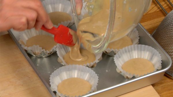 Pour the batter into the liners evenly. Use a spatula to clean the bowl, distributing the remaining batter.