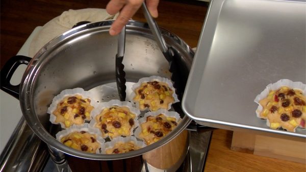 Turn off the burner and place the cupcake tins onto a tray with the tongs.