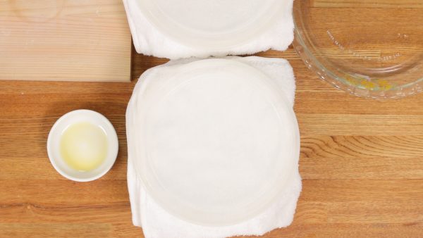 Cover each bowl with a dampened towel. Then, place a lid on the bowls. Rest the dough in a warm place at approximately 35 °C (95 °F) for about 1 hour.