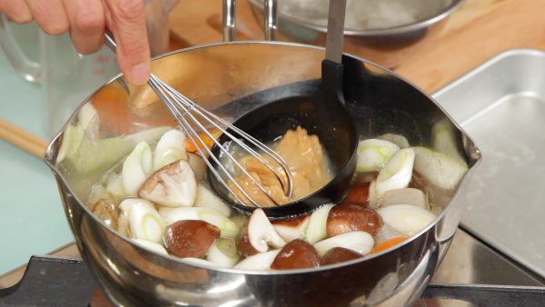 Place about half of the miso into a ladle and dissolve it with a portion of the broth. Then, combine the dissolved miso and the broth.