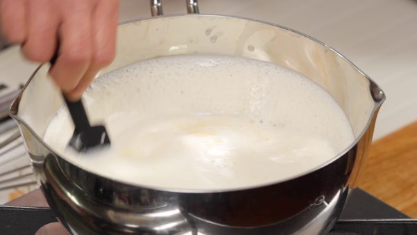 Then, pour the mixture into another pot. Heat it on low heat while stirring. Be careful not to bring it to a boil.