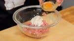 Add the panko moistened with milk and egg. Squeeze the mixture to combine all the ingredients.