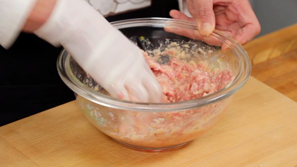 Then, loosely spread your fingers forming a rake shape to thoroughly mix the meat until it turns gooey. This will help to combine the ingredients.