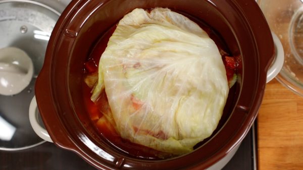 Cover the ingredients with the last cabbage leaf, but you can skip this if there aren't any left.