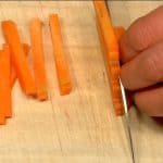 Slice the carrot into 5mm (0.2") slices. Stack the layers and chop them into 5mm (0.2") strips.