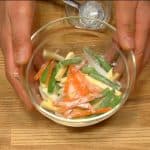 Place the vegetable strips into a bowl. Add a little tempura flour and toss to coat evenly.
