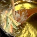 Gently slide the mixture into the oil. Keep the vegetable strips together.