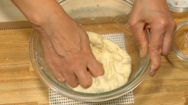 Gather the flour together with your hand. Knead until the dough ball is smooth and clean inside the mixing bowl.