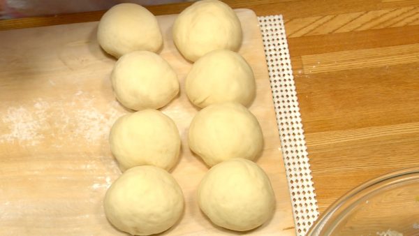 Shape each piece of dough into a ball while keeping the surface smooth.