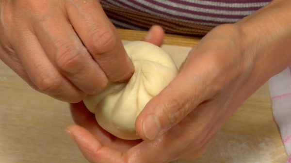 Twist and fold the dough up to the top to wrap the mixture.