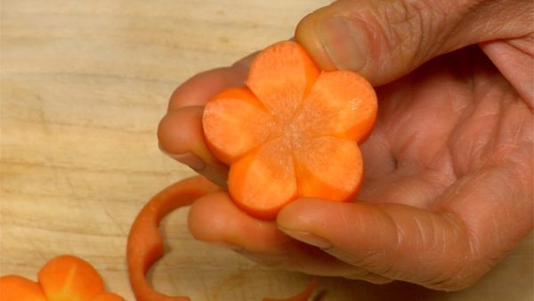 Cut between the petals to give it a plum blossom shape.
