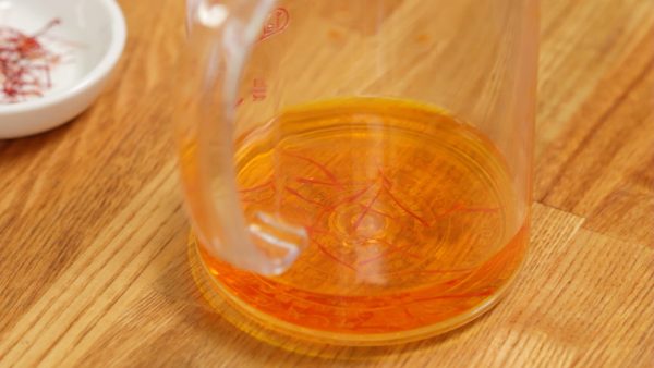 Soak the saffron threads in the water for over 20 minutes to extract the color.