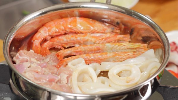 Lightly brown the prawns, and then flip them over. Flip the squid rings also to avoid overcooking.