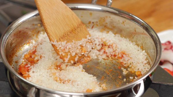 Now, reduce the heat to low. Add the rice. Japanese rice has a sticky texture so the rice is often sauted to help separate each grain.