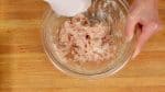 Loosely spread your fingers forming a rake shape, and mix the meat mixture until it turns gooey.