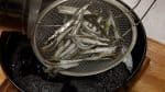 Turn off the burner, remove the kombu seaweed and place it onto a cutting board. Strain the stock into a pot with a mesh strainer, removing the baby sardines.
