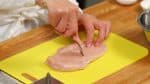 First, let’s prepare the chicken. Pierce the skinless chicken breast in numerous places with a fork.