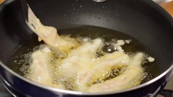 Coat the chicken with the batter and gently place the chicken into the oil one piece at a time.