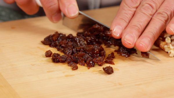 Next, chop the rum-soaked raisins into fine pieces.