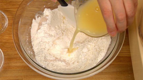 溶き卵と水を合わせ、これを粉に注ぎながら混ぜます。