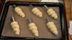 With the closed side facing down, gently press the dough onto a baking sheet covered with a non-stick oven liner.