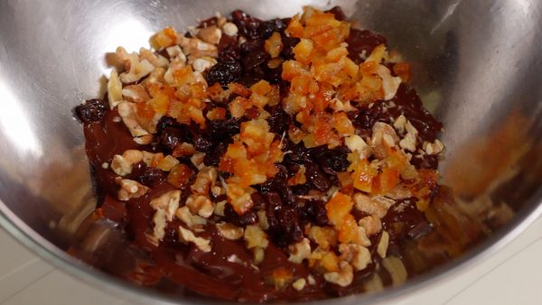 Remove the bowl. Add the walnuts, rum raisins, chopped candied orange peel and the corn flakes.